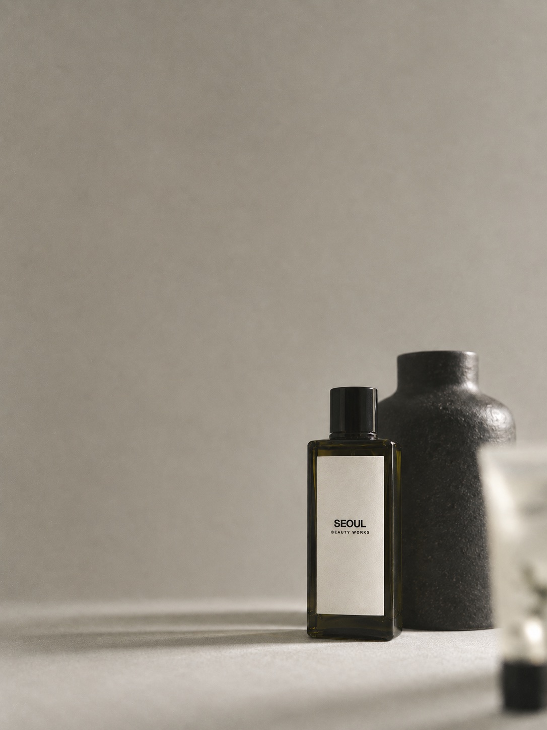Illustrative SEOUL BEAUTY WORKS skincare packaging in a warm vintage studio